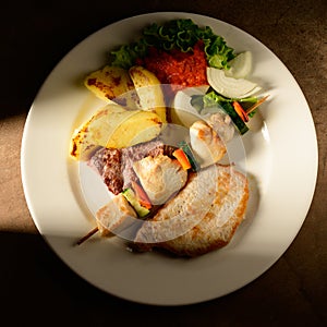 Mixed Grilled meat and vegetables decorated on a plate ready to be served in restaurant