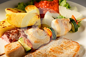 Mixed Grilled meat and vegetables decorated on a plate ready to be served in restaurant