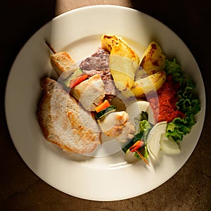 Mixed Grilled meat and vegetables decorated on a plate ready to be served in restaurant