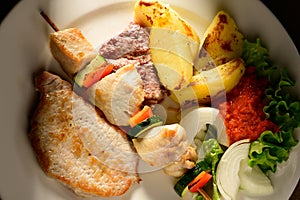 Mixed Grilled meat and vegetables decorated on a plate ready to be served in restaurant