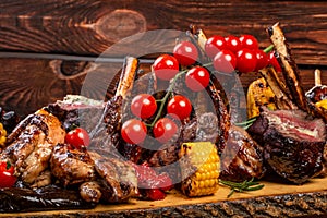 Mixed Grilled meat and vegetables on wooden background