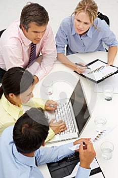 Mixed group in business meeting around table