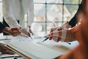 Mixed group of business people sitting around a table and working, Business team working on a project in the office around a table