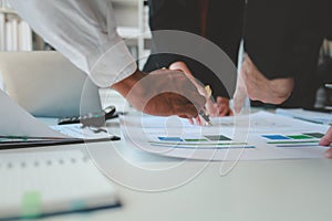 Mixed group of business people sitting around a table and working, Business team working on a project in the office around a table