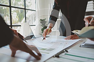 Mixed group of business people sitting around a table and working, Business team working on a project in the office around a table