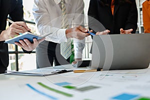 Mixed group of business people sitting around a table and working, Business team working on a project in the office around a table