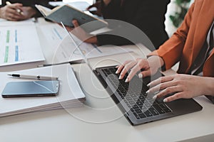 Mixed group of business people sitting around a table and working, Business team working on a project in the office around a table