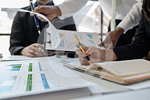 Mixed group of business people sitting around a table and working, Business team working on a project in the office around a table