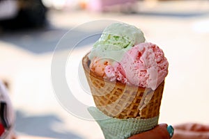 Mixed ice cream scoops with cone on white background