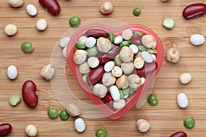 Mixed legume beans in a heart bowl photo