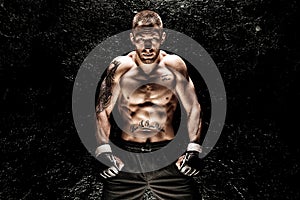 Mixed martial artist posing on a black background. Concept of mma, ufc, thai boxing, classic boxing