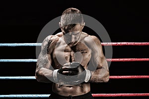 Mixed martial artist posing in boxing ring. Concept of mma, ufc, thai boxing, classic boxing