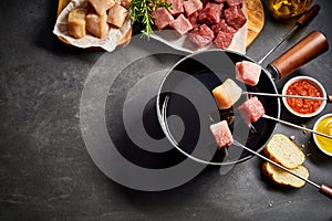 Mixed meat fondue with seasoning and dips