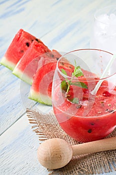 Mixed melon in a glass with ice and straw