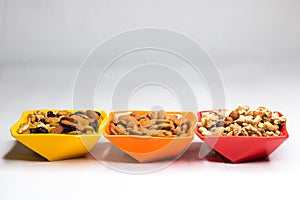 Mixed nuts in  colored bowls