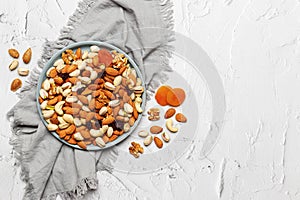 Mixed nuts and dried fruits in a plate on a light concrete background. Symbols of the Jewish holiday of Tu Bishvat Healthy snack