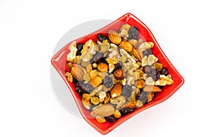 Mixed nuts in red bowl isolated