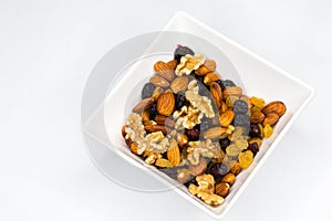 Mixed nuts in white bowl isolated