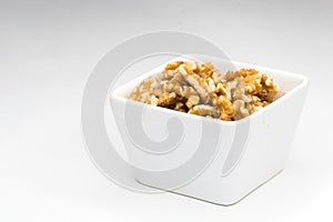 Mixed nuts in white bowl isolated
