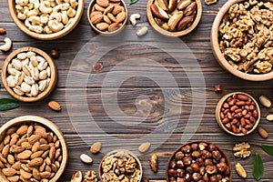 mixed nuts in wooden bowl. Mix of various nuts on colored background. pistachios, cashews, walnuts, hazelnuts, peanuts