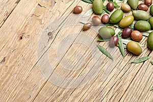 Mixed olives and green leaves background, close up view