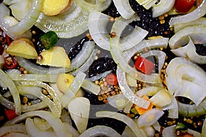 Mixed onions, ginger, pepper, seeds, tumeric root in a pan