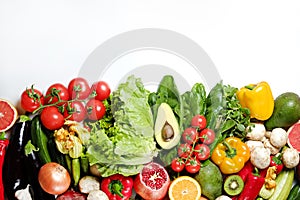 Mixed organic vegetables and greens isolated on white background.
