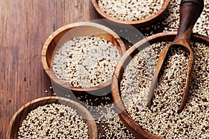 Mixed quinoa in bowl on wooden kitchen table. Healthy and diet superfood product