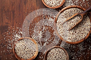 Mixed quinoa in bowl on wooden kitchen table top view. Healthy and diet superfood product