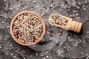 Mixed quinoa red, white and brown quinoa in wooden bowl. Healthy and gluten free food. banner, menu, recipe, place for text. top