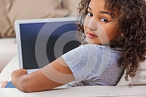 Mixed Race African American Girl Child Using Laptop or Tablet Computer