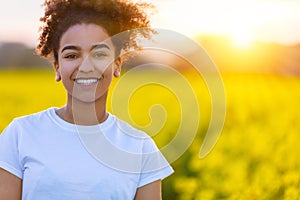 Mixed Race African American Girl In a Field of Yellow Flowers at Sunset or Sunrise