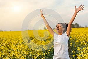 Mixed Race African American Girl Teenager Celebrating In Yellow