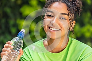 Mixed Race African American Girl Teenager Drinking From a Water Bottle