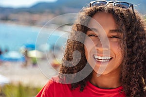 Mixed Race African American Girl Teenager Laughing By Beach