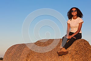 Mixed Race African American Girl Teenager Sitting on Hay Bale