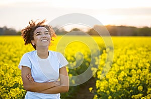 Mixed Race African American Girl Teenager Smiling Happy In Yellow Flowers