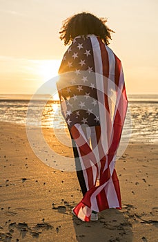 Mixed Race African American Girl Woman Wrapped in US Flag Beach