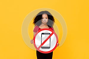 Mixed race African girl showing no mobile phone usage sign photo