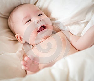 Mixed Race Baby Boy Having Fun on His Blanket