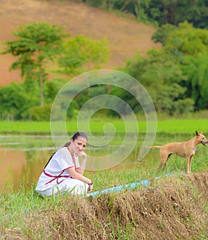 Mixed-race beautiful karen girl sit on rice field