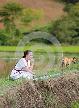 Mixed-race beautiful karen girl sit on rice field