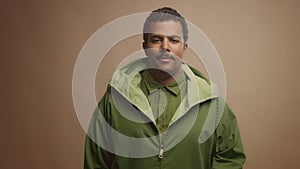 Mixed race black man on beige background in studio portrait