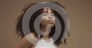 Mixed race black woman portrait with big afro hair, curly hair