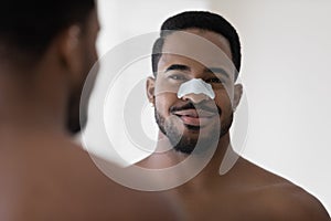 Mixed race Black young man with cleansing strip on nose