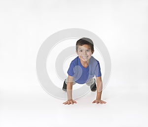 Mixed race boy doing push ups