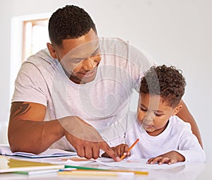 Mixed race boy learning and studying in homeschool with dad. Man helping his son with homework and assignments at home