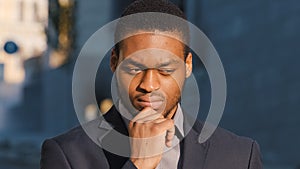 Mixed Race businessman holding sign Need Work points index finger. Portrait of Young man standing outdoor hold poster