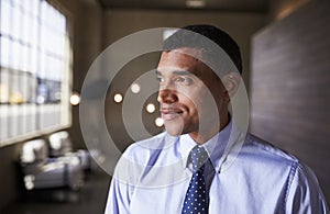 Mixed race businessman looking away smiling, close up