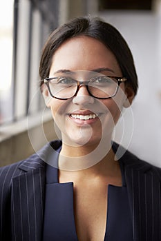 Mixed race businesswoman wearing glasses, close up, vertical